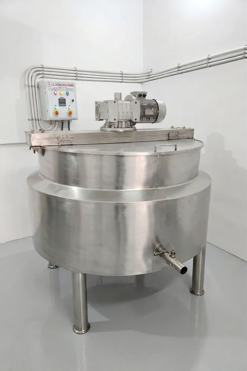 A stainless-steel steam-jacketed kettle with a mechanical stirrer, used for kwaths and syrups at Prabhat's Amritsar factory